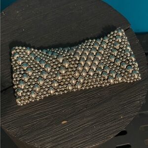 Sergio Gutierrez liquid metal bracelet 8”
length snap closure 1.5” wide